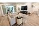 Comfortable living room with stylish decor, including a modern sofa, side table, and patio view at 5972 5Th S Ave, St Petersburg, FL 33707