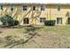 Exterior view of a home with a well-maintained yard, patio, and lush shrubbery at 8539 Sandpiper Ridge Ave, Tampa, FL 33647