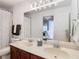 Bathroom featuring a double sink vanity, decorative shower curtain, and a large mirror with vanity lighting at 8539 Sandpiper Ridge Ave, Tampa, FL 33647