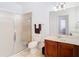 This is a cozy bathroom with a glass shower door and nice sink with a wood cabinet at 8539 Sandpiper Ridge Ave, Tampa, FL 33647