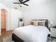 This primary bedroom features a ceiling fan, rug, wood floors and a mirror at 8539 Sandpiper Ridge Ave, Tampa, FL 33647