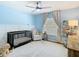 Charming Bedroom with soft blue walls, wooden accents, and a comfortable rocking chair for relaxation at 8539 Sandpiper Ridge Ave, Tampa, FL 33647