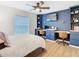 Bedroom featuring a built-in desk area, ceiling fan, bright window, and ample overhead lighting at 8539 Sandpiper Ridge Ave, Tampa, FL 33647