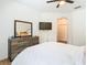 This is the primary bedroom that features wood floors, ceiling fan, tv and a mirror at 8539 Sandpiper Ridge Ave, Tampa, FL 33647