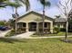Exterior of a clubhouse with manicured lawn and mature landscaping at 8539 Sandpiper Ridge Ave, Tampa, FL 33647