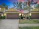 Charming townhome with two-car garage, manicured lawn, and an American flag at 8539 Sandpiper Ridge Ave, Tampa, FL 33647