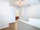 Second-floor hallway showing wood floors and white walls with bathroom view and access to other rooms at 8539 Sandpiper Ridge Ave, Tampa, FL 33647