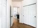 Bright hallway with wood floors, closet space, and views into other rooms at 8539 Sandpiper Ridge Ave, Tampa, FL 33647
