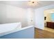 Bright hallway with wood floors leading to rooms, showcasing the home's layout and access to various spaces at 8539 Sandpiper Ridge Ave, Tampa, FL 33647