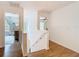 Bright hallway leading to rooms with neutral tones, wood flooring, and natural light shining through windows at 8539 Sandpiper Ridge Ave, Tampa, FL 33647