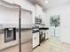Kitchen featuring stainless steel appliances, white cabinetry, and adjoining laundry room at 8539 Sandpiper Ridge Ave, Tampa, FL 33647