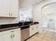 Modern kitchen features white cabinets, granite countertops, and stainless steel appliances at 8539 Sandpiper Ridge Ave, Tampa, FL 33647