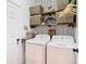 Organized laundry room with shelving, patterned wallpaper, and washer/dryer units at 8539 Sandpiper Ridge Ave, Tampa, FL 33647
