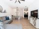 Bright living room featuring wood floors, modern furnishings, and an open layout leading to the kitchen at 8539 Sandpiper Ridge Ave, Tampa, FL 33647