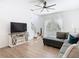 The living room features a tv, fan, large sectional and an oversized window at 8539 Sandpiper Ridge Ave, Tampa, FL 33647