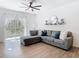 The living room features an oversized window, fan and view to the dining room at 8539 Sandpiper Ridge Ave, Tampa, FL 33647