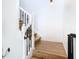 Staircase with wood steps and white railing, featuring a modern design and a safety gate installed at 8539 Sandpiper Ridge Ave, Tampa, FL 33647