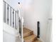 Staircase with white wooden steps and ornate black metal railings for a stylish transition to the next level at 8539 Sandpiper Ridge Ave, Tampa, FL 33647