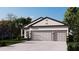 Charming single-story home featuring a two-car garage and lush, green landscaping for curb appeal at 121 Indian Creek Dr, Rotonda West, FL 33947