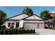 Inviting single-story home with a two-car garage, complemented by well-manicured landscaping at 121 Indian Creek Dr, Rotonda West, FL 33947