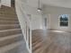 Living room with stairs, wood floors, and natural light at 4200 Cocoanut Ave, Sarasota, FL 34234