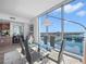 Modern dining room with floor-to-ceiling windows, a glass table, and stunning waterfront views at 5120 Marina Way # 12003, Tampa, FL 33611