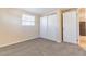Bedroom featuring neutral carpet, a window with blinds, and a large closet at 10151 114Th N Ter, Largo, FL 33773