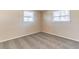 Cozy bedroom featuring neutral carpet, two windows with blinds, and light colored walls at 10151 114Th N Ter, Largo, FL 33773