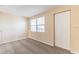 Bedroom featuring neutral carpet, window with blinds, closet, and light colored walls at 10151 114Th N Ter, Largo, FL 33773