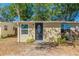 Close-up of home's front door and window showing landscape and architectural design at 10151 114Th N Ter, Largo, FL 33773