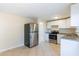 Contemporary kitchen featuring stainless steel refrigerator and oven and bright white cabinets at 10151 114Th N Ter, Largo, FL 33773