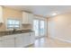 Bright kitchen featuring tile floors, granite countertops, and a window over sink at 10151 114Th N Ter, Largo, FL 33773