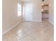 Bright living room with tile flooring, white baseboards, and access to the kitchen at 10151 114Th N Ter, Largo, FL 33773