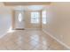 Bright living room with tile flooring and natural light featuring the front door entrance at 10151 114Th N Ter, Largo, FL 33773