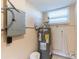 Basement utility area featuring a well-maintained water heater and electrical panel at 10151 114Th N Ter, Largo, FL 33773