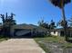 Hurricane damage to home; garage door has failed and debris is scattered in the yard at 1810 New Hampshire Ne Ave, St Petersburg, FL 33703