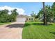 Charming home with a lush green lawn, a paved driveway, and a well-manicured front yard at 1810 New Hampshire Ne Ave, St Petersburg, FL 33703