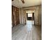 Living room under renovation with new tile flooring and open doorway to the adjacent room at 1810 New Hampshire Ne Ave, St Petersburg, FL 33703