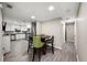 Open living area with wood-look floors, dining table, and modern kitchen in the background at 1810 New Hampshire Ne Ave, St Petersburg, FL 33703