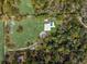 Expansive estate features a modern home, pool, surrounded by lush greenery and mature trees, offering privacy at 18526 Sweetbay Ln, Dade City, FL 33523