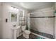 This bathroom has marble tile in the shower, black accent stripes, and patterned flooring at 18526 Sweetbay Ln, Dade City, FL 33523