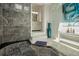 Elegant bathroom showcasing the stylish shower with steps and a modern vanity in the background at 18526 Sweetbay Ln, Dade City, FL 33523