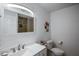 Bright bathroom featuring a sleek vanity with modern fixtures and a stylish mirror at 18526 Sweetbay Ln, Dade City, FL 33523