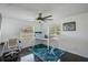 Bedroom with a bunk bed, desk, ceiling fan, and natural light at 18526 Sweetbay Ln, Dade City, FL 33523