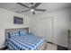 Bedroom with a fan and a bed with a wooden base and headboard at 18526 Sweetbay Ln, Dade City, FL 33523