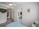 Modern bedroom with open doorway to living space and stylish gray tile flooring at 18526 Sweetbay Ln, Dade City, FL 33523