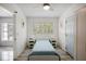 Simple bedroom with a bed, two side tables, and a window providing natural light at 18526 Sweetbay Ln, Dade City, FL 33523