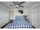 Cozy bedroom featuring a ceiling fan and a bed with a gray headboard at 18526 Sweetbay Ln, Dade City, FL 33523