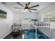 Bedroom with a bunk bed, desk, and large ceiling fan, great for  at 18526 Sweetbay Ln, Dade City, FL 33523