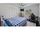 Bedroom with a blue-checkered bed, a desk, and a window with natural light at 18526 Sweetbay Ln, Dade City, FL 33523